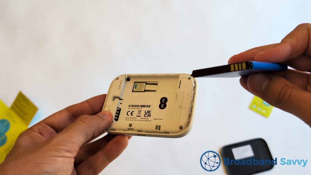 Showing the four gold pins on the battery and inside the MiFi device.