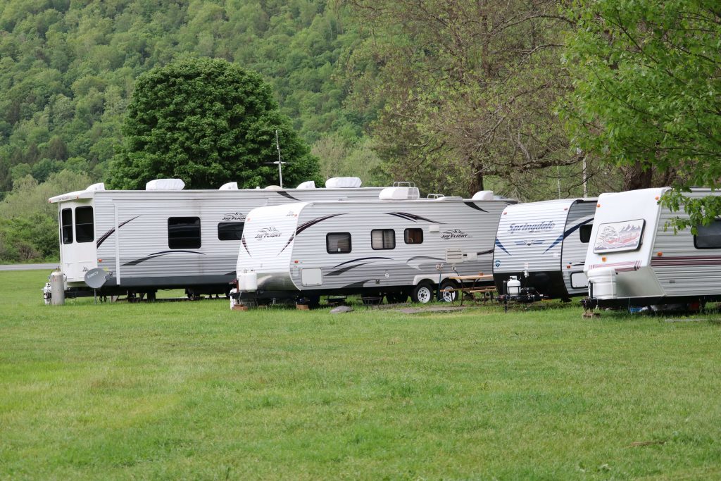 Row of caravans in a field.