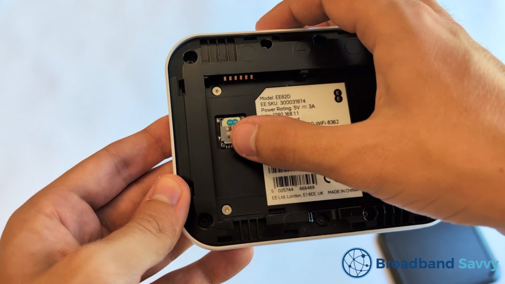 Inserting the SIM card into the EE 5G WiFi device.