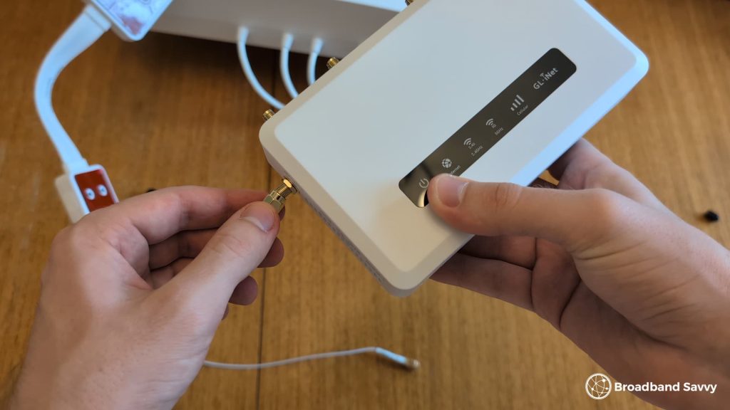 Screwing the antenna cables into the router.