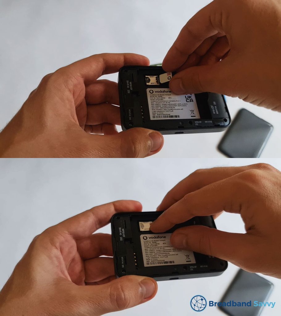 Inserting the SIM card into the Vodafone MiFi device.