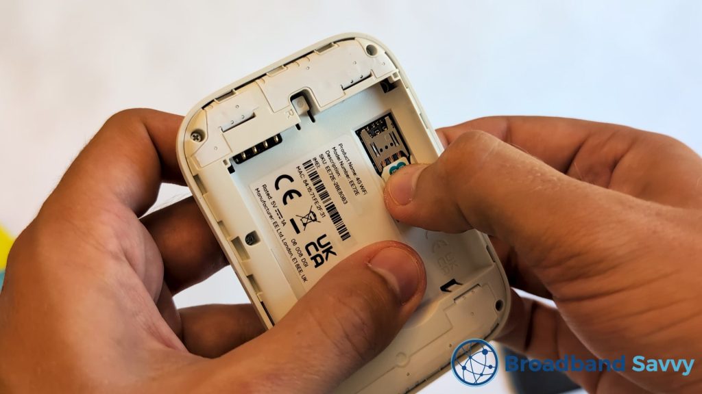 Inserting the SIM card into the EE 4G MiFi device.