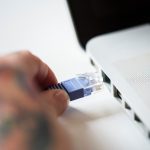 5 Best Broadband Alternatives | Get Internet Without Fibre Person plugging an Ethernet internet cable into a laptop.