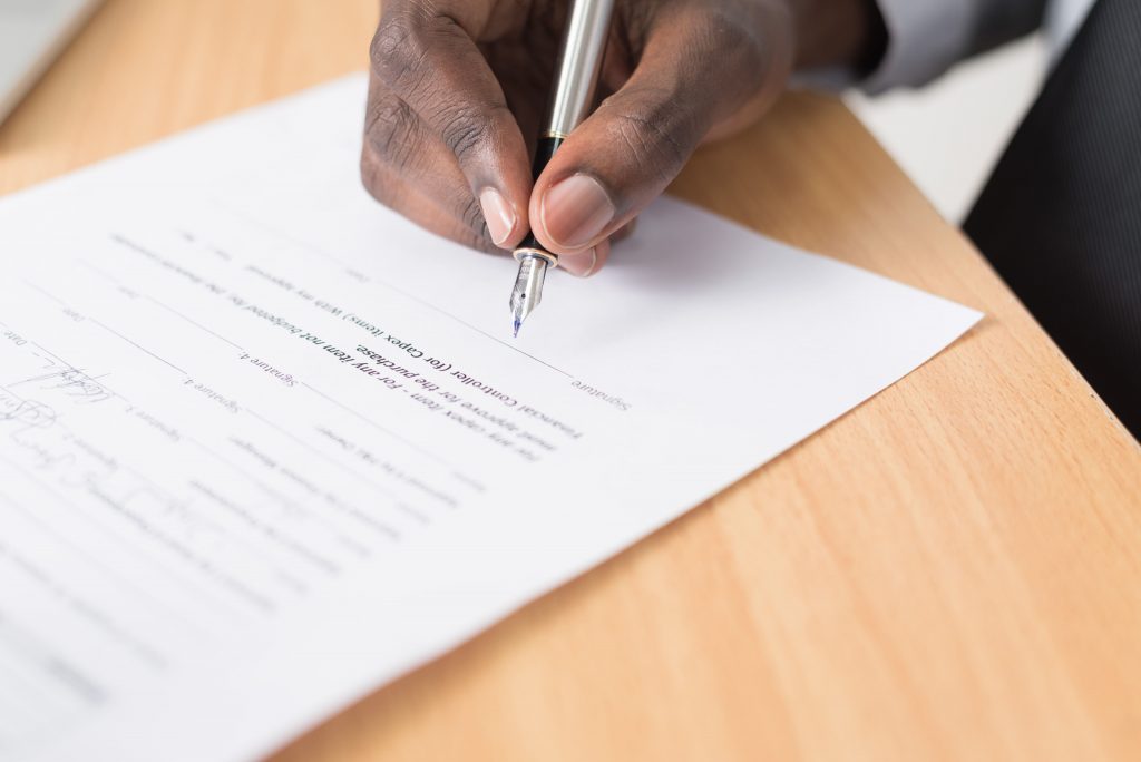 Person signing a broadband contract.