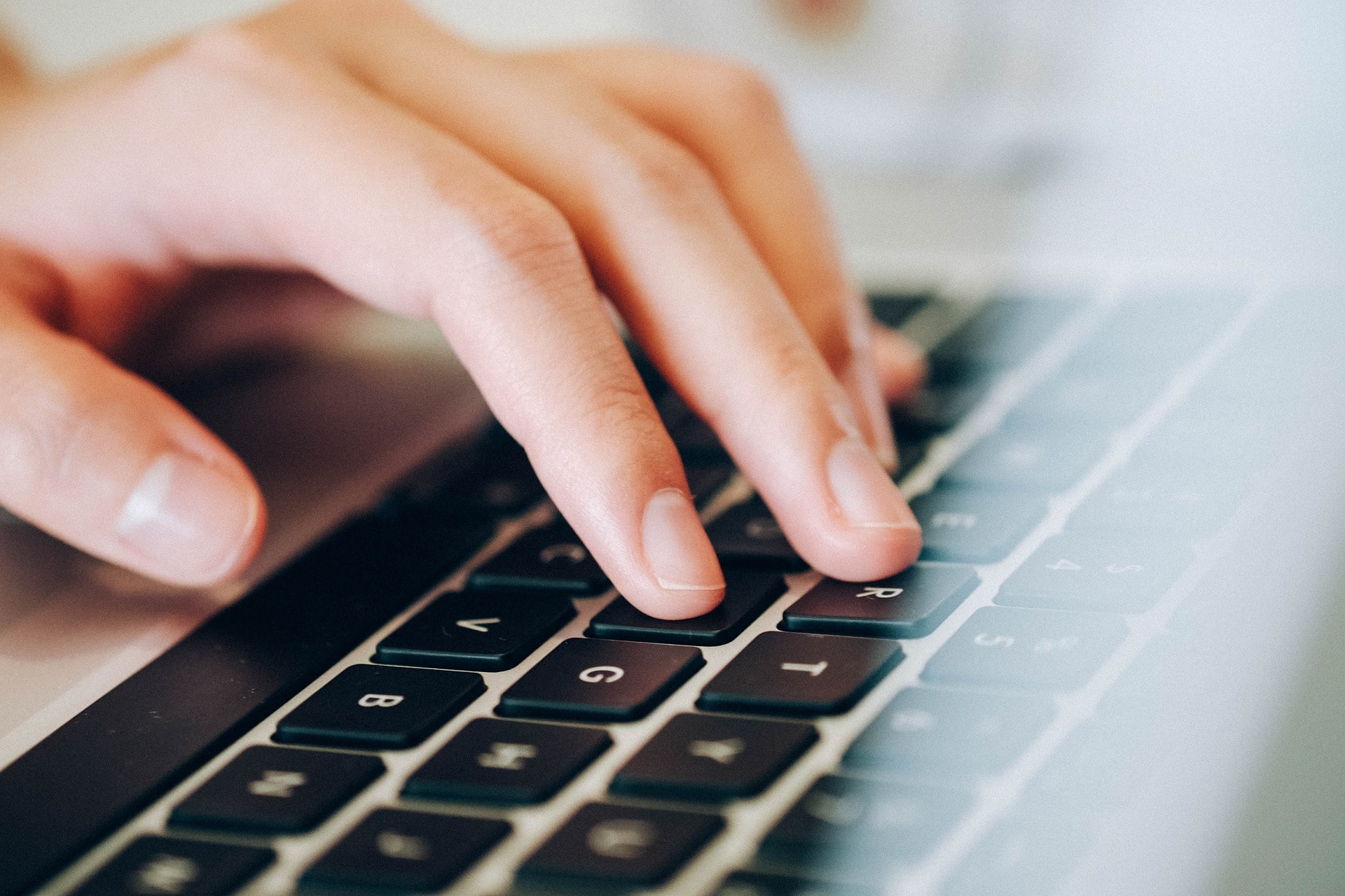 Person typing on a laptop.