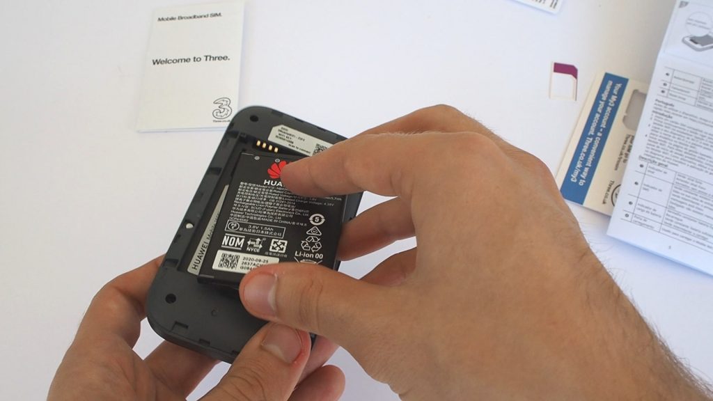 Placing the battery in the Three Huawei MiFi device.
