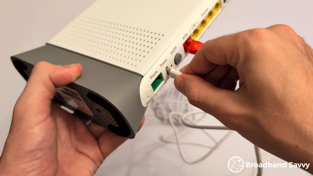 Plugging the Smart Hub 7 Plus into power.