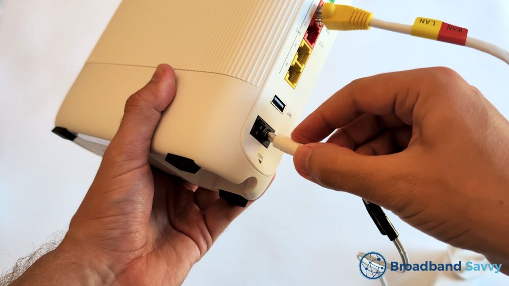 Plugging power cable into the router.