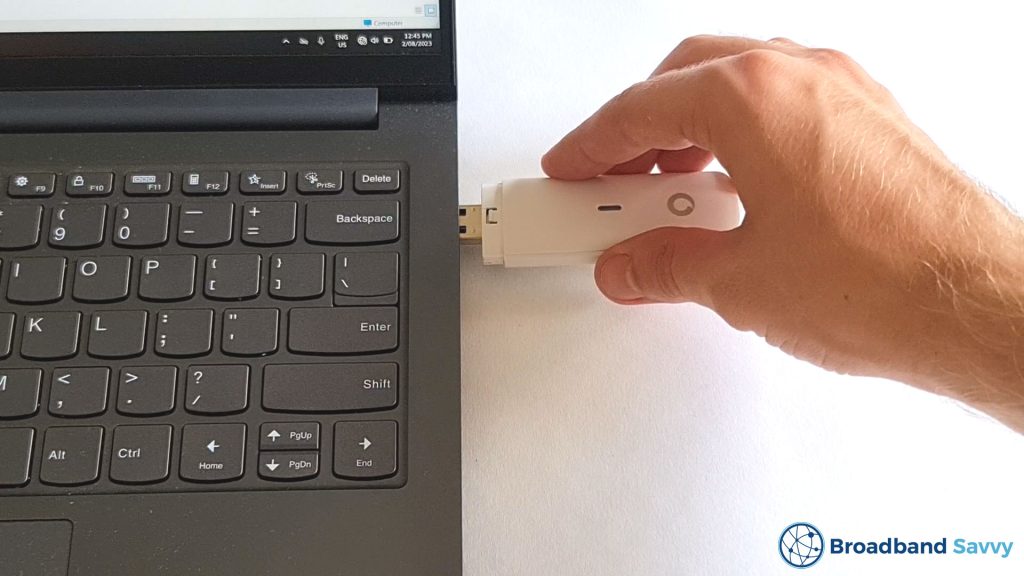Plugging the Vodafone dongle into a computer.