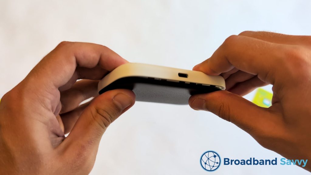 Reattaching the back cover of the mobile Wi-Fi device.