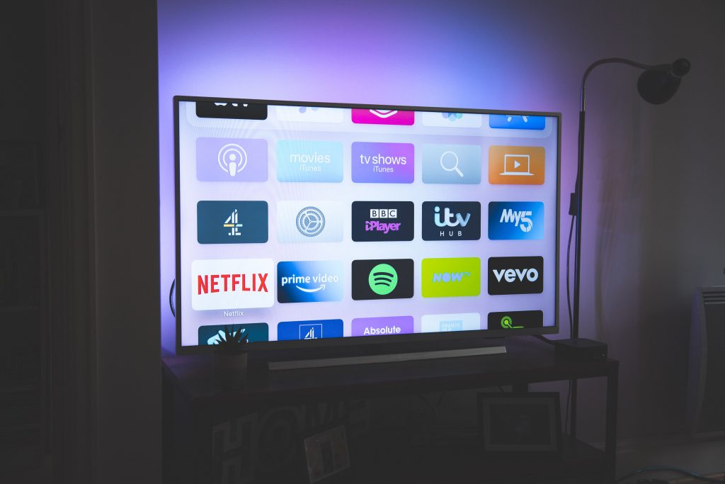 A smart TV with a number of TV apps displayed on the screen.