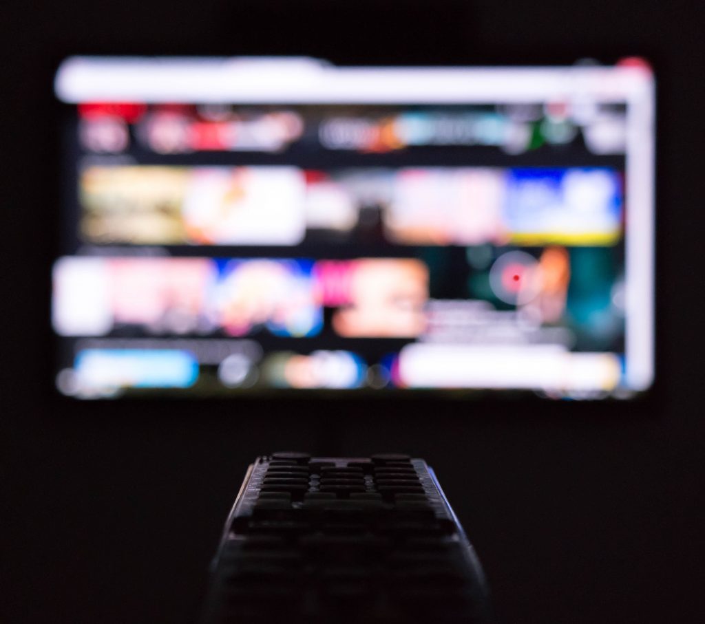 Person using a TV remote.