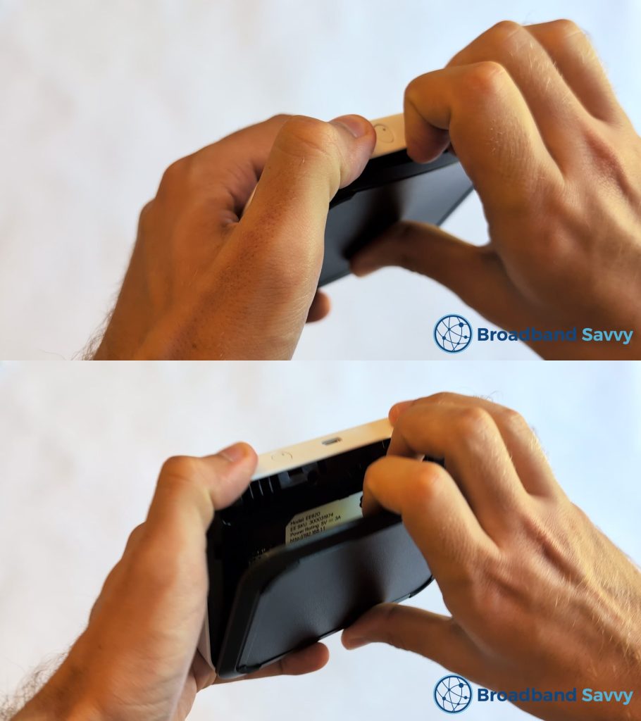 Unclipping the back cover on the MiFi device.