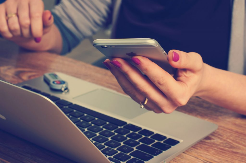 Woman setting up a mobile hotspot on her phone.